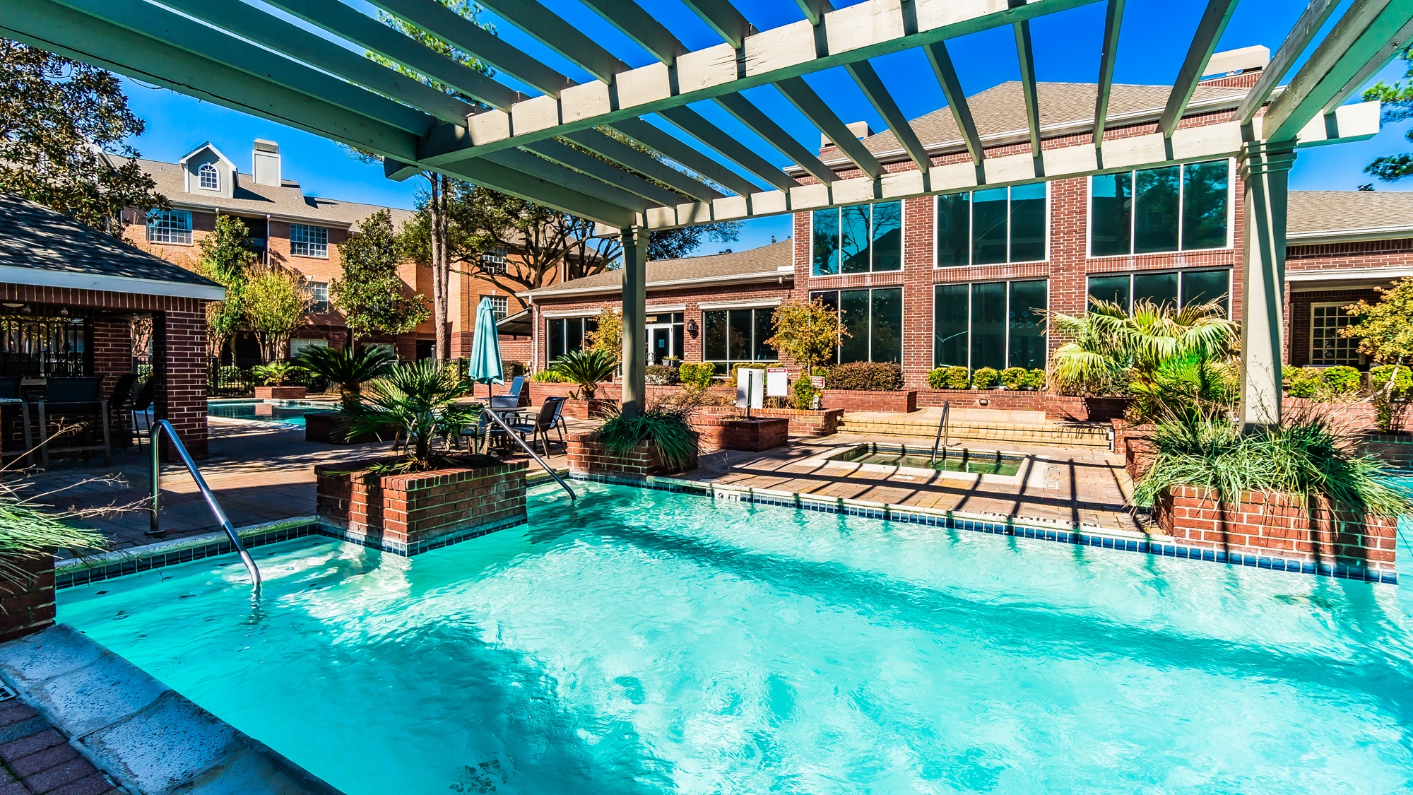 A swimming pool under a covered patio area.